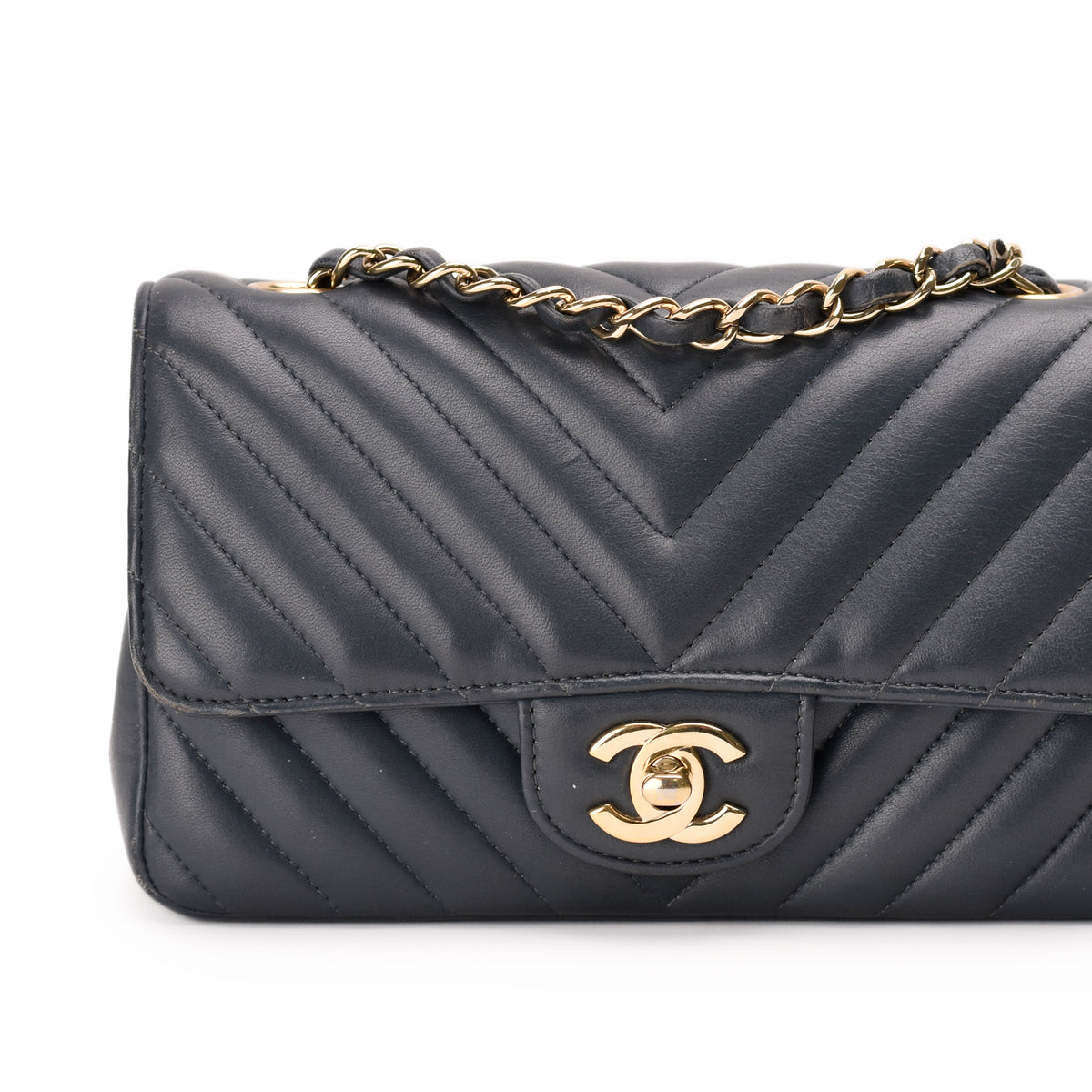 Black quilted leather Chanel flap bag with gold-tone chain strap, curated Pre-loved Luxury by Myluxe in Helsinki.