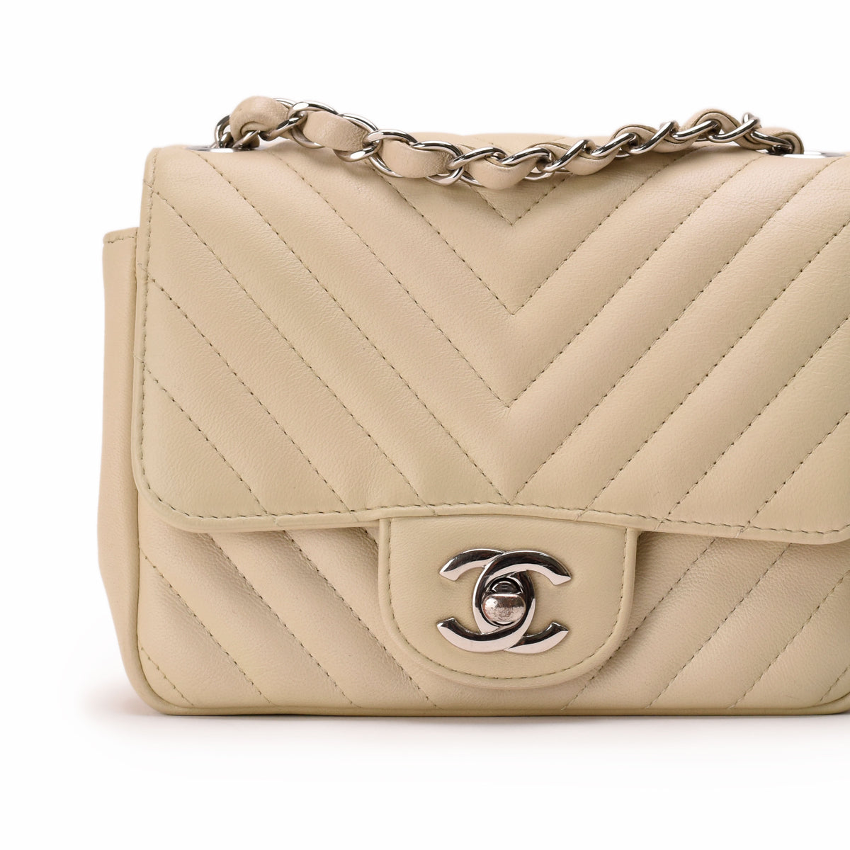 Beige chevron quilted leather Chanel handbag with silver chain strap, curated Pre-loved Luxury by Myluxe in Helsinki.