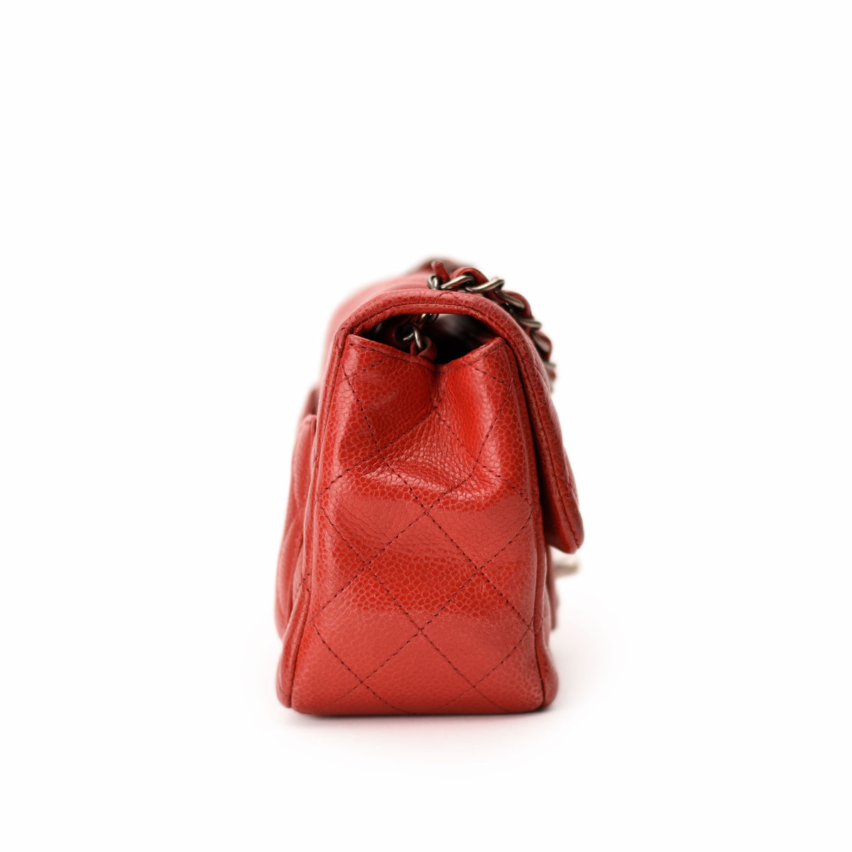 Red quilted lambskin Chanel handbag with chain strap. curated Pre-loved Luxury by Myluxe in Helsinki.