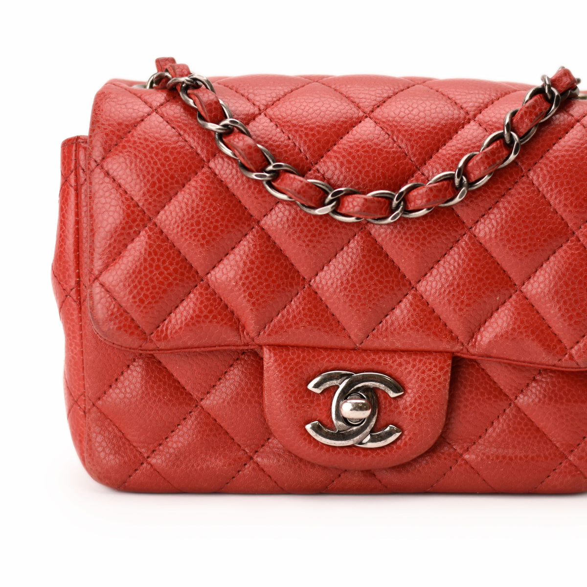Red quilted leather Chanel flap bag with silver chain strap. curated Pre-loved Luxury by Myluxe in Helsinki.