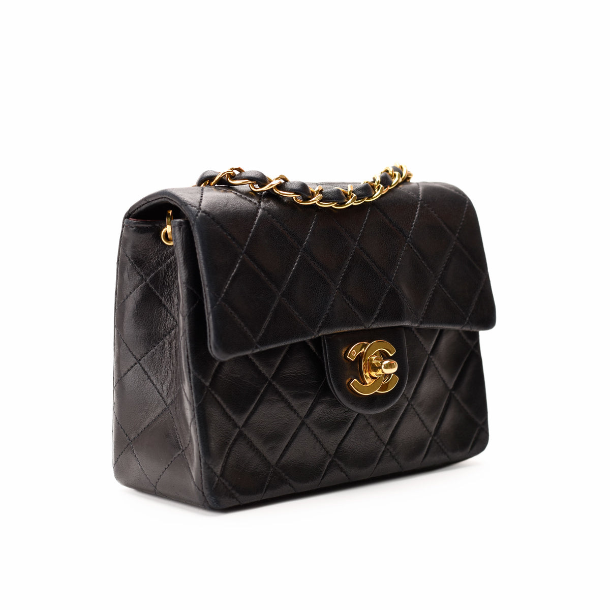 Black quilted lambskin Chanel flap bag with gold-tone hardware, curated Pre-loved Luxury by Myluxe in Helsinki.