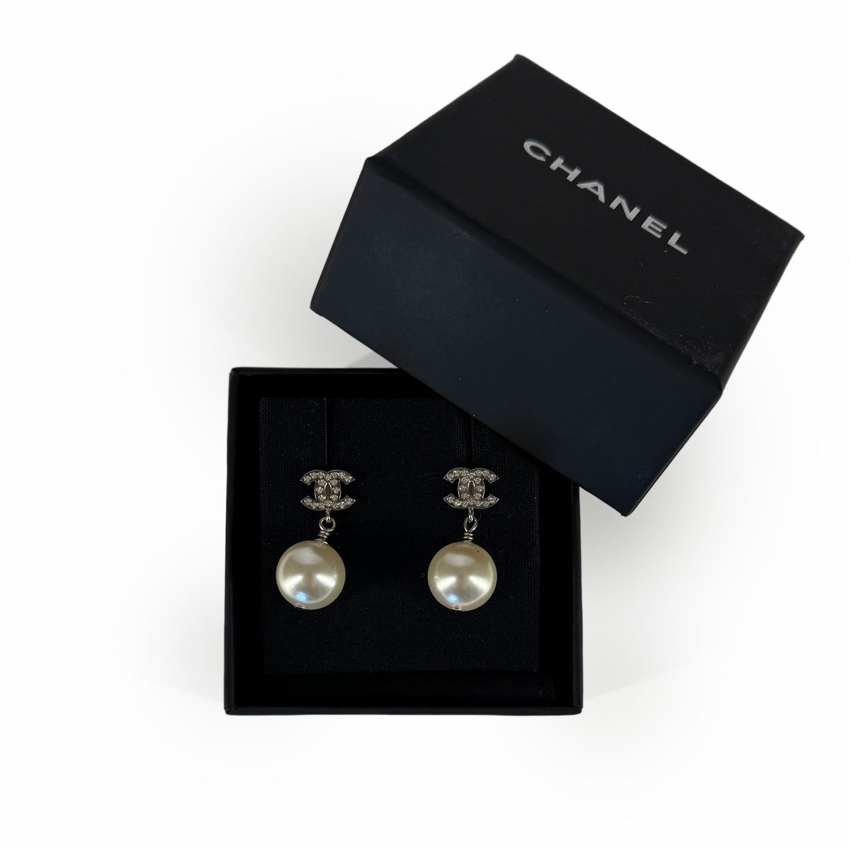 Chanel silver-tone CC logo pearl drop earrings in a black Chanel box, curated Pre-loved Luxury by Myluxe in Helsinki.