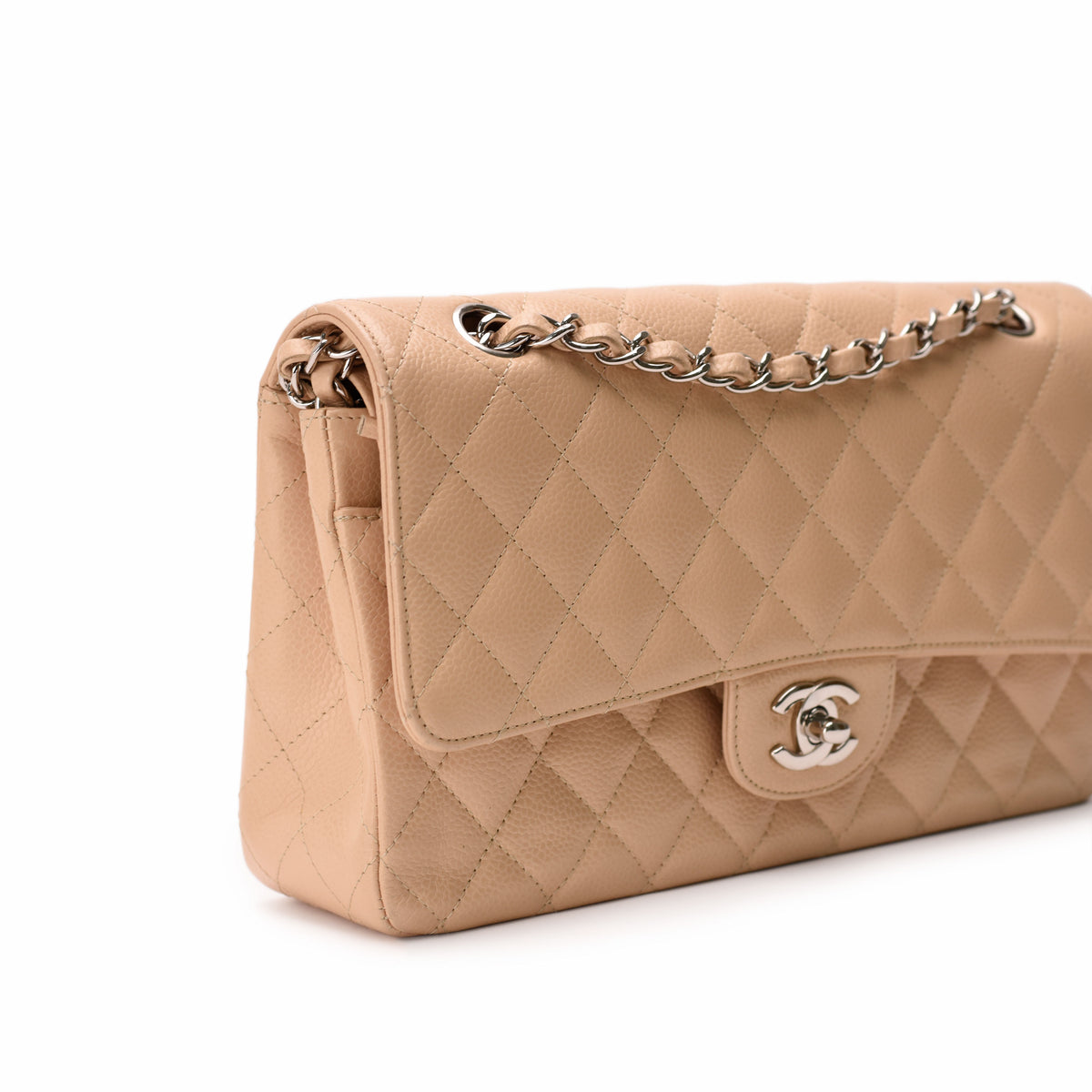 Beige quilted lambskin Chanel flap bag with silver chain strap, curated Pre-loved Luxury by Myluxe in Helsinki.