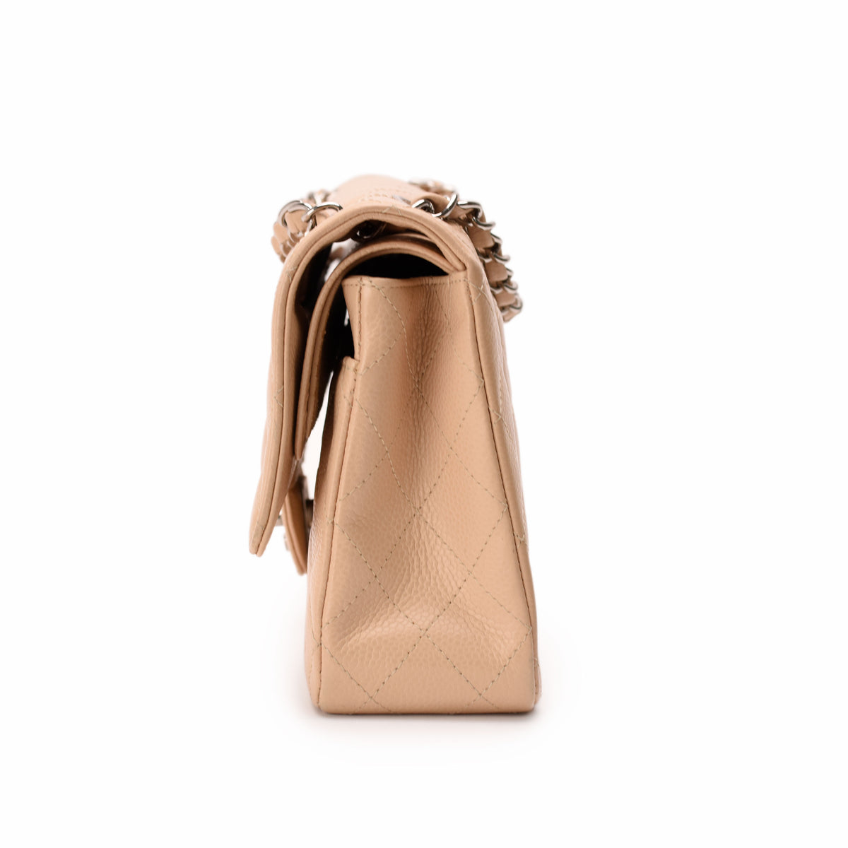 Beige quilted leather Chanel flap bag with silver chain strap, curated Pre-loved Luxury by Myluxe in Helsinki.