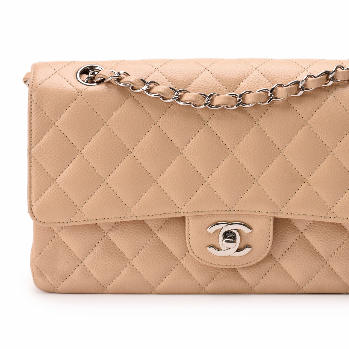 Beige quilted lambskin Chanel flap bag with silver chain strap, curated Pre-loved Luxury by Myluxe in Helsinki.