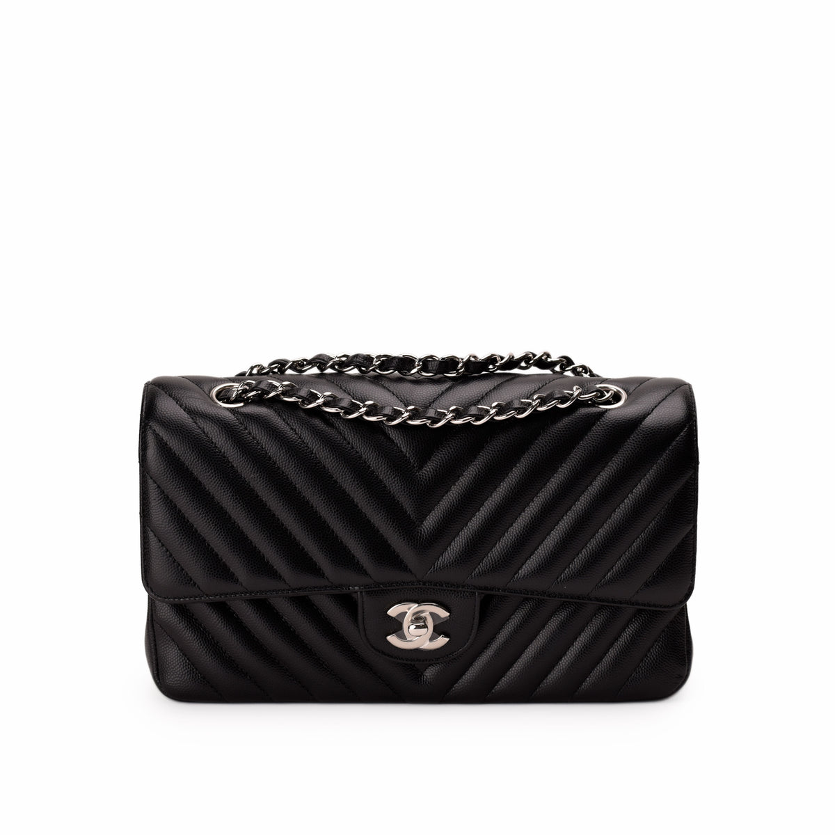 Black chevron quilted leather Chanel flap bag with silver chain strap, curated Pre-loved Luxury by Myluxe in Helsinki.