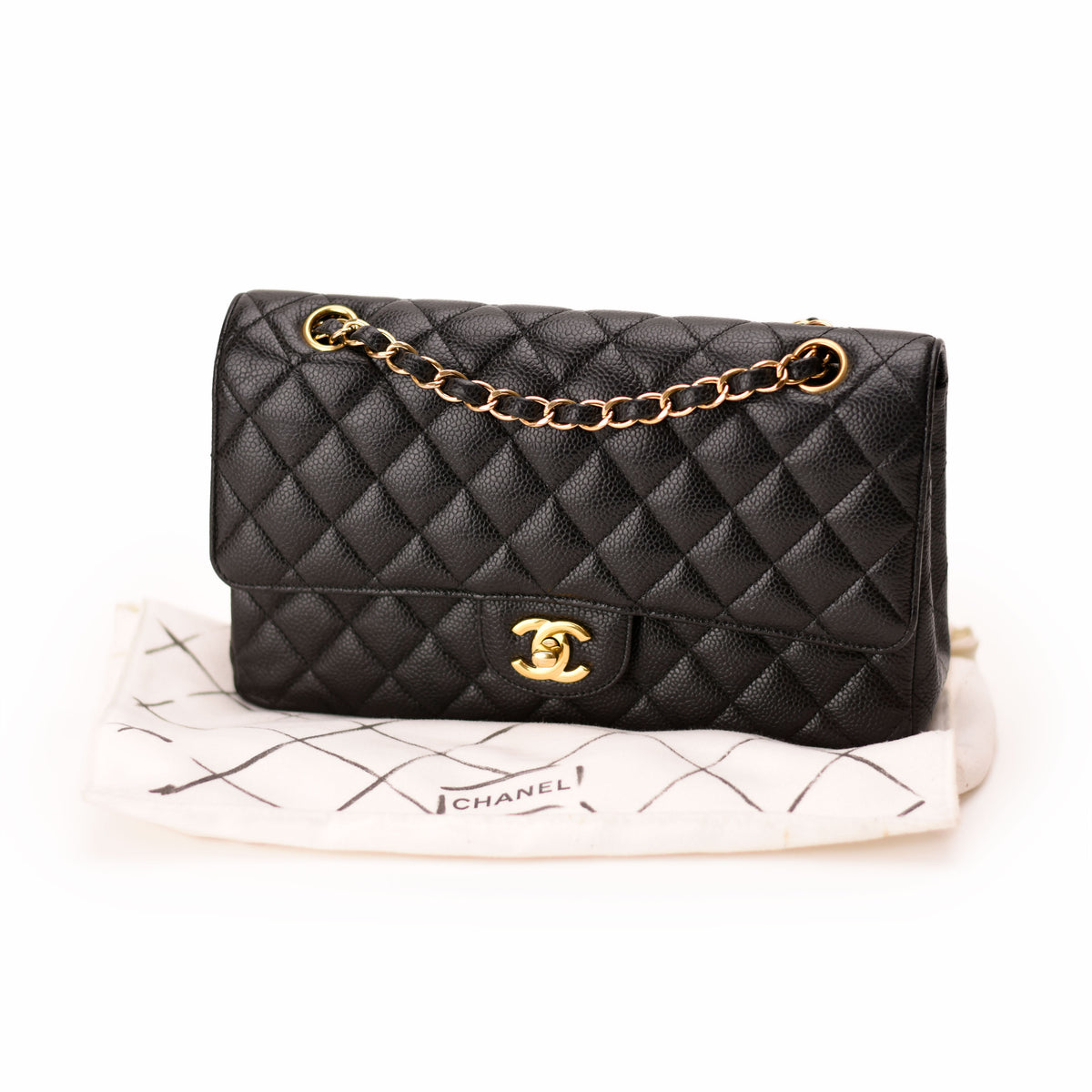 Black quilted leather Chanel handbag with gold chain strap and CC logo, curated Pre-loved Luxury by Myluxe in Helsinki.
