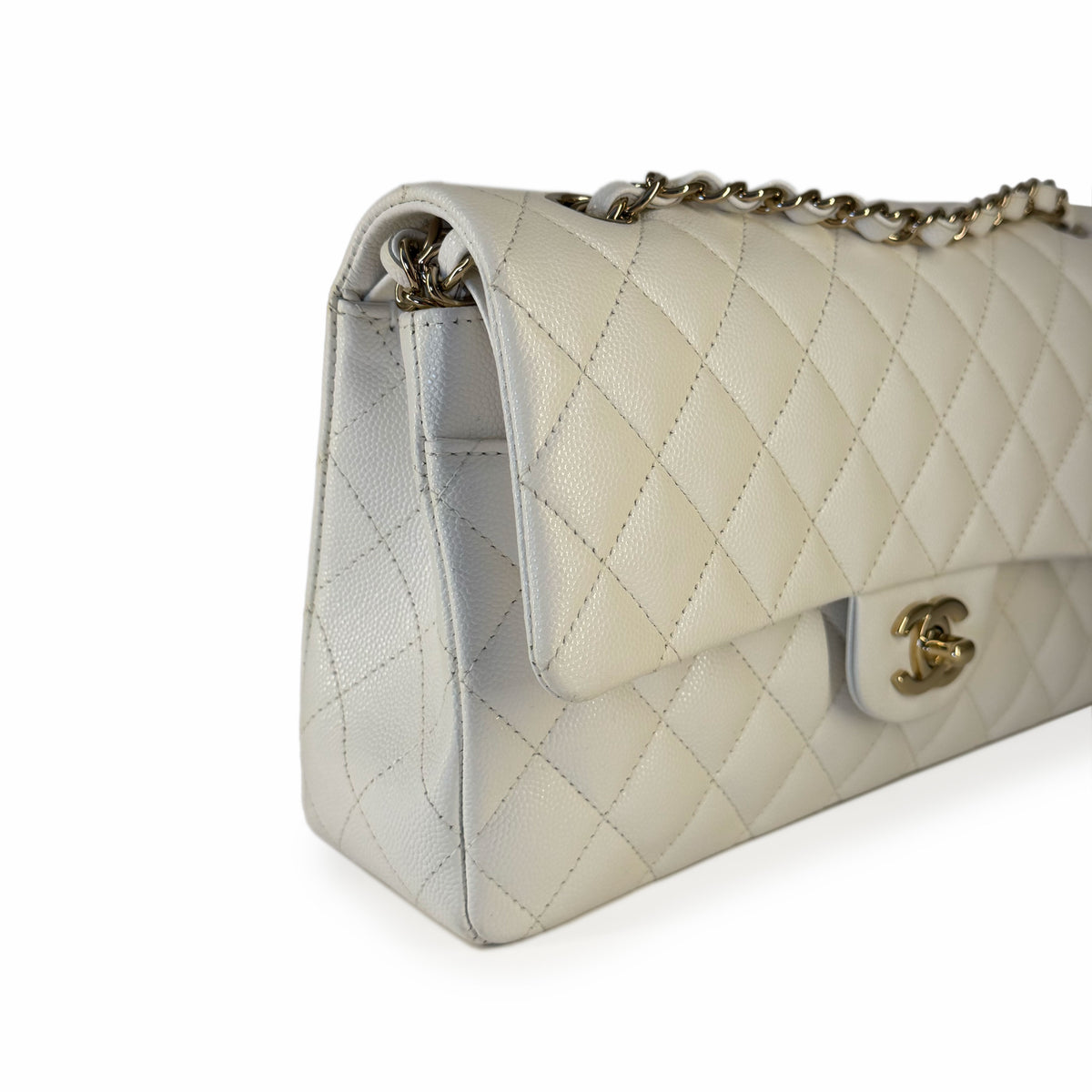 White quilted caviar leather Chanel flap bag with silver chain strap, curated Pre-loved Luxury by Myluxe in Helsinki.