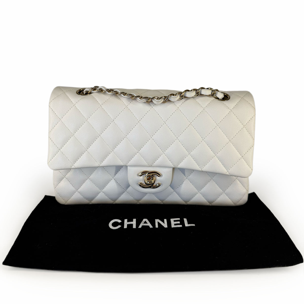White quilted leather Chanel flap bag with silver chain strap, curated Pre-loved Luxury by Myluxe in Helsinki.