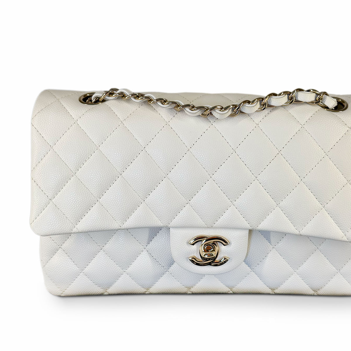 White quilted caviar leather Chanel flap bag with silver chain strap, curated Pre-loved Luxury by Myluxe in Helsinki.
