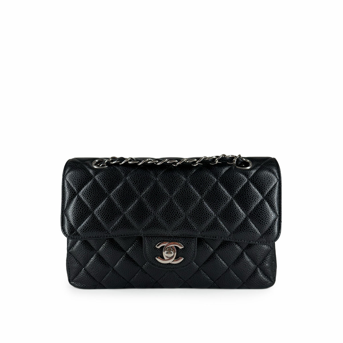 Black quilted caviar leather Chanel flap bag with silver chain strap, curated Pre-loved Luxury by Myluxe in Helsinki.