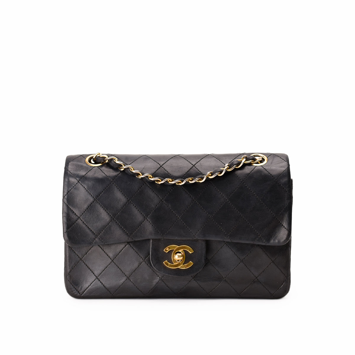 Black quilted leather Chanel handbag with gold-tone chain strap and CC lock, curated Pre-loved Luxury by Myluxe in Helsinki.