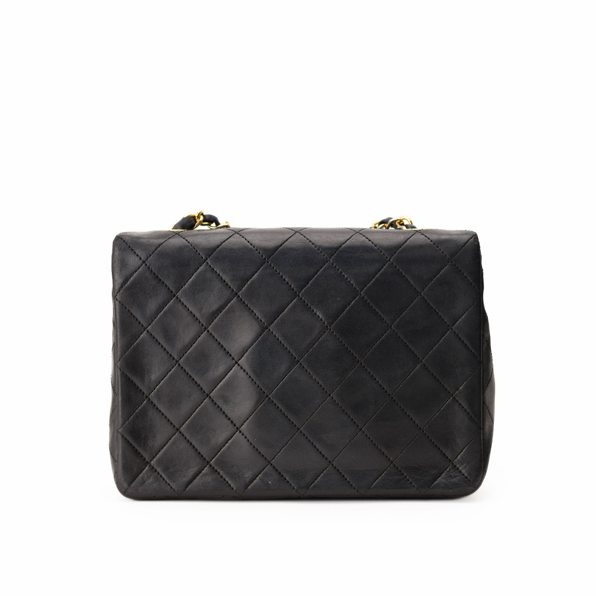 Black quilted leather Chanel shoulder bag with gold chain strap, curated Pre-loved Luxury by Myluxe in Helsinki.