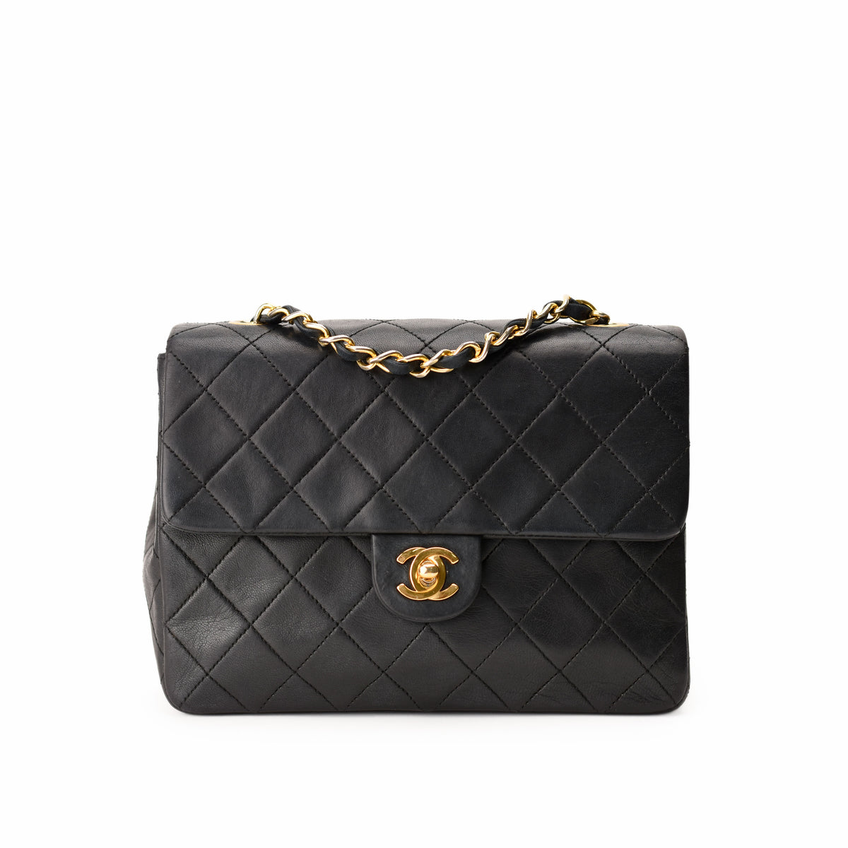 Black quilted leather Chanel handbag with gold chain and CC logo. curated Pre-loved Luxury by Myluxe in Helsinki.