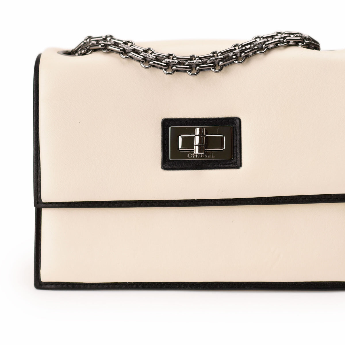 Cream leather Chanel flap bag with silver chain strap. curated Pre-loved Luxury by Myluxe in Helsinki.