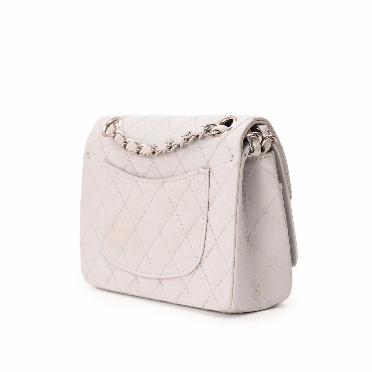 White quilted leather handbag with silver chain strap, curated Pre-loved Luxury by Myluxe in Helsinki.