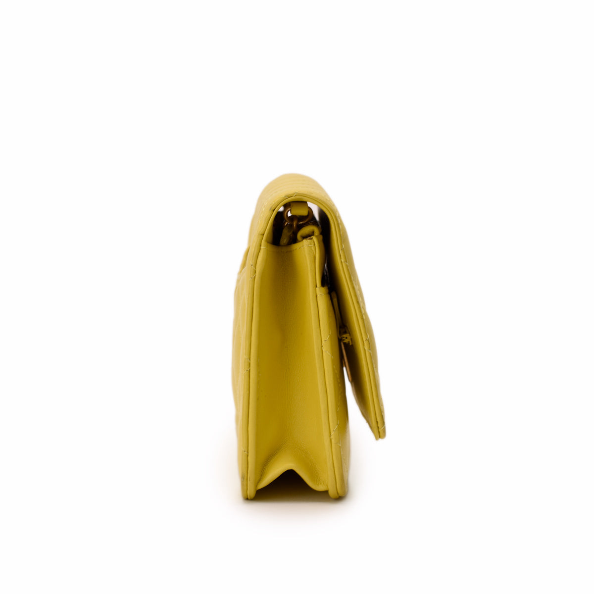 Side view of a yellow quilted leather clutch bag, curated Pre-loved Luxury by Myluxe in Helsinki.