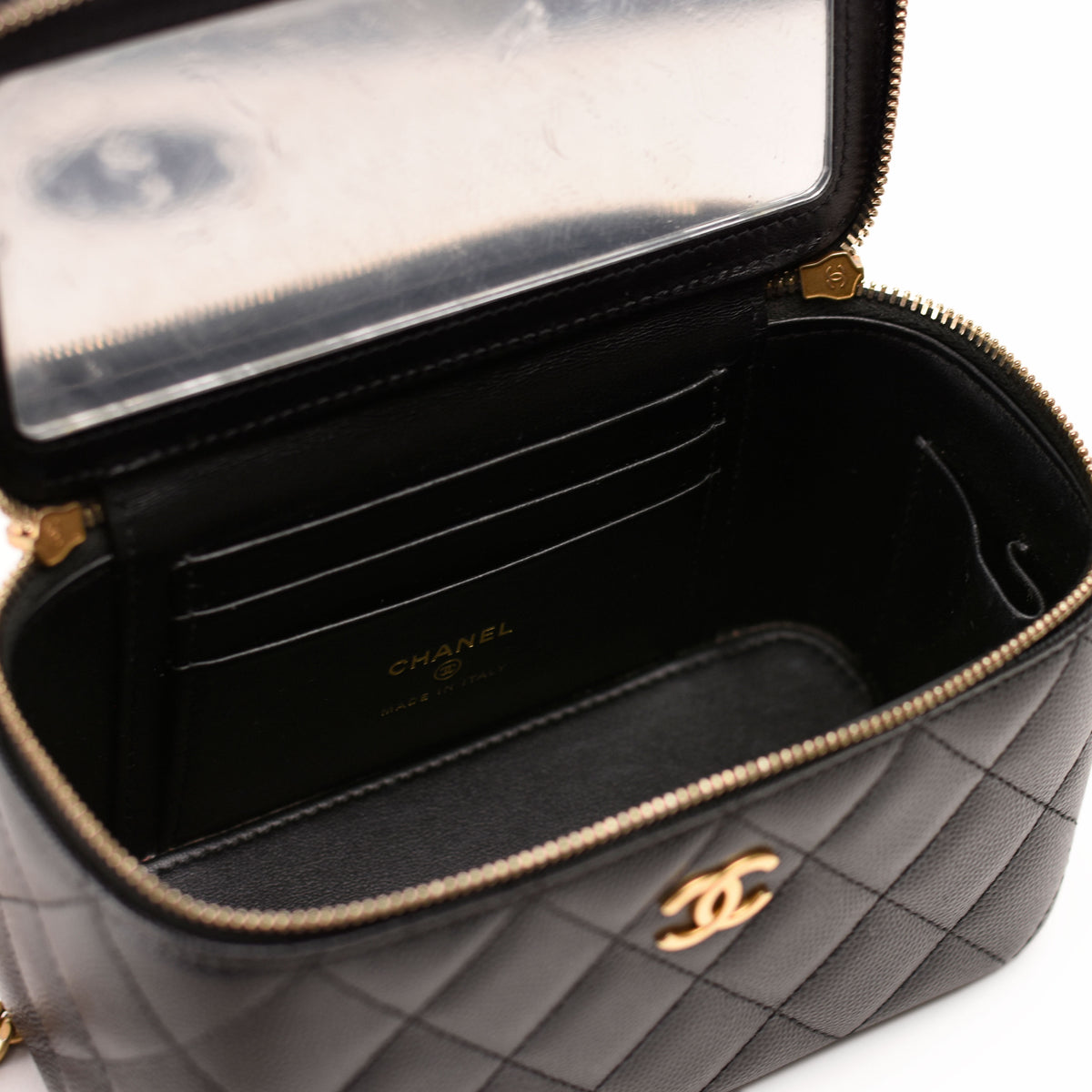 Interior of a black quilted leather Chanel handbag with gold hardware, curated Pre-loved Luxury by Myluxe in Helsinki.