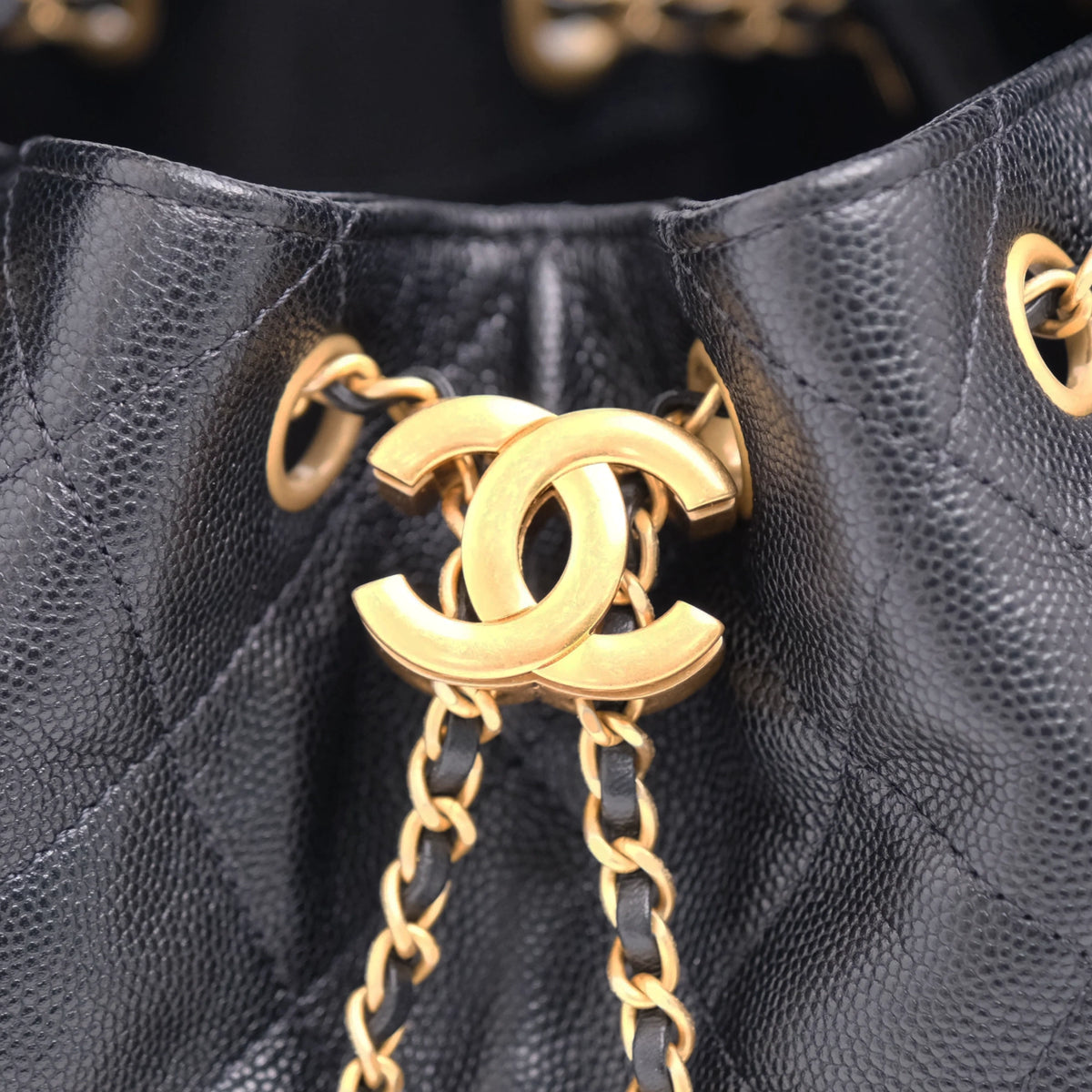 Chanel black caviar leather bucket bag with gold-tone interlocking CC hardware. curated Pre-loved Luxury by Myluxe in Helsinki.