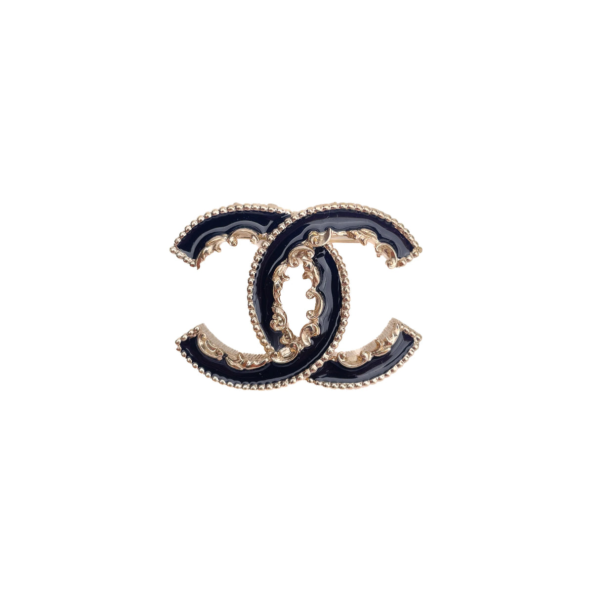 Chanel interlocking CC logo brooch in black enamel and gold-tone metal, curated Pre-loved Luxury by Myluxe in Helsinki.