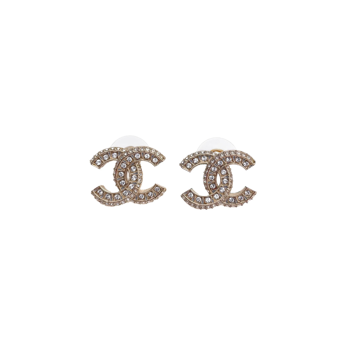 Chanel interlocking CC stud earrings in gold-tone metal with clear crystals, curated Pre-loved Luxury by Myluxe in Helsinki.