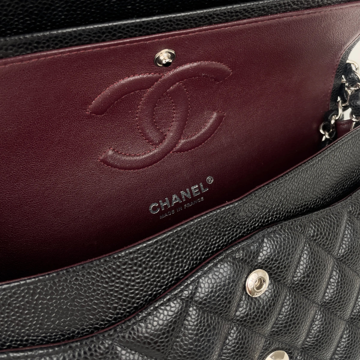 Chanel black quilted caviar leather handbag with burgundy interior, curated Pre-loved Luxury by Myluxe in Helsinki.