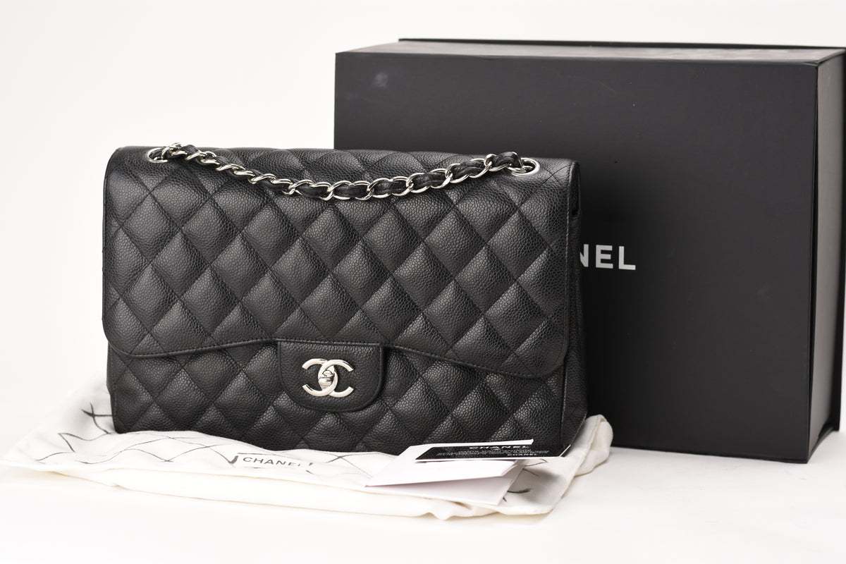 Chanel Timeless Jumbo black caviar leather flap bag with silver hardware. curated Pre-loved Luxury by Myluxe in Helsinki.