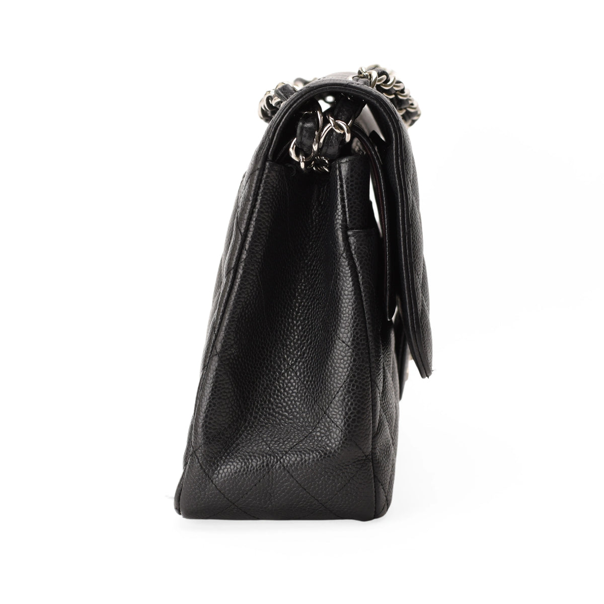 Side view of a Chanel Timeless Jumbo black caviar leather handbag with silver hardware. curated Pre-loved Luxury by Myluxe in Helsinki.