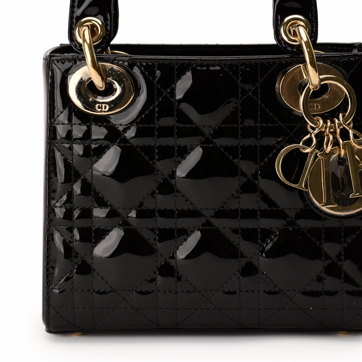 Black patent leather Dior Lady Dior handbag with gold-tone hardware. curated Pre-loved Luxury by Myluxe in Helsinki.