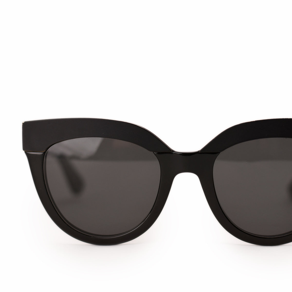 Black acetate cat-eye sunglasses with dark tinted lenses. curated Pre-loved Luxury by Myluxe in Helsinki.