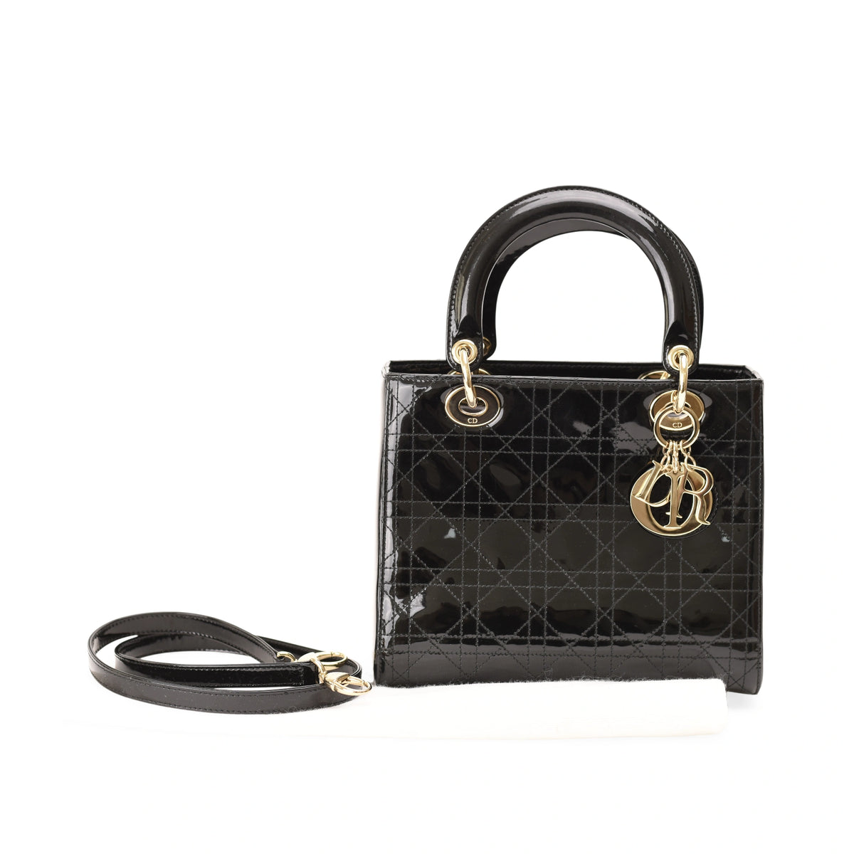 Black patent leather Dior Lady Dior handbag with gold-tone hardware. curated Pre-loved Luxury by Myluxe in Helsinki.