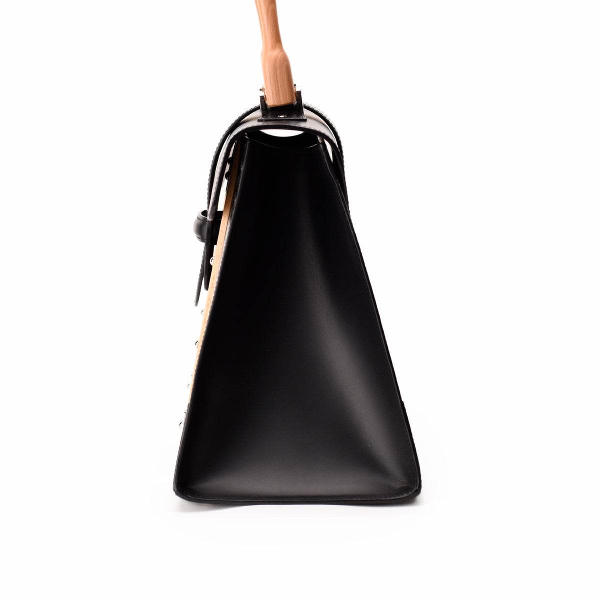 Side view of a black leather structured handbag with a light wood handle, curated Pre-loved Luxury by Myluxe in Helsinki.