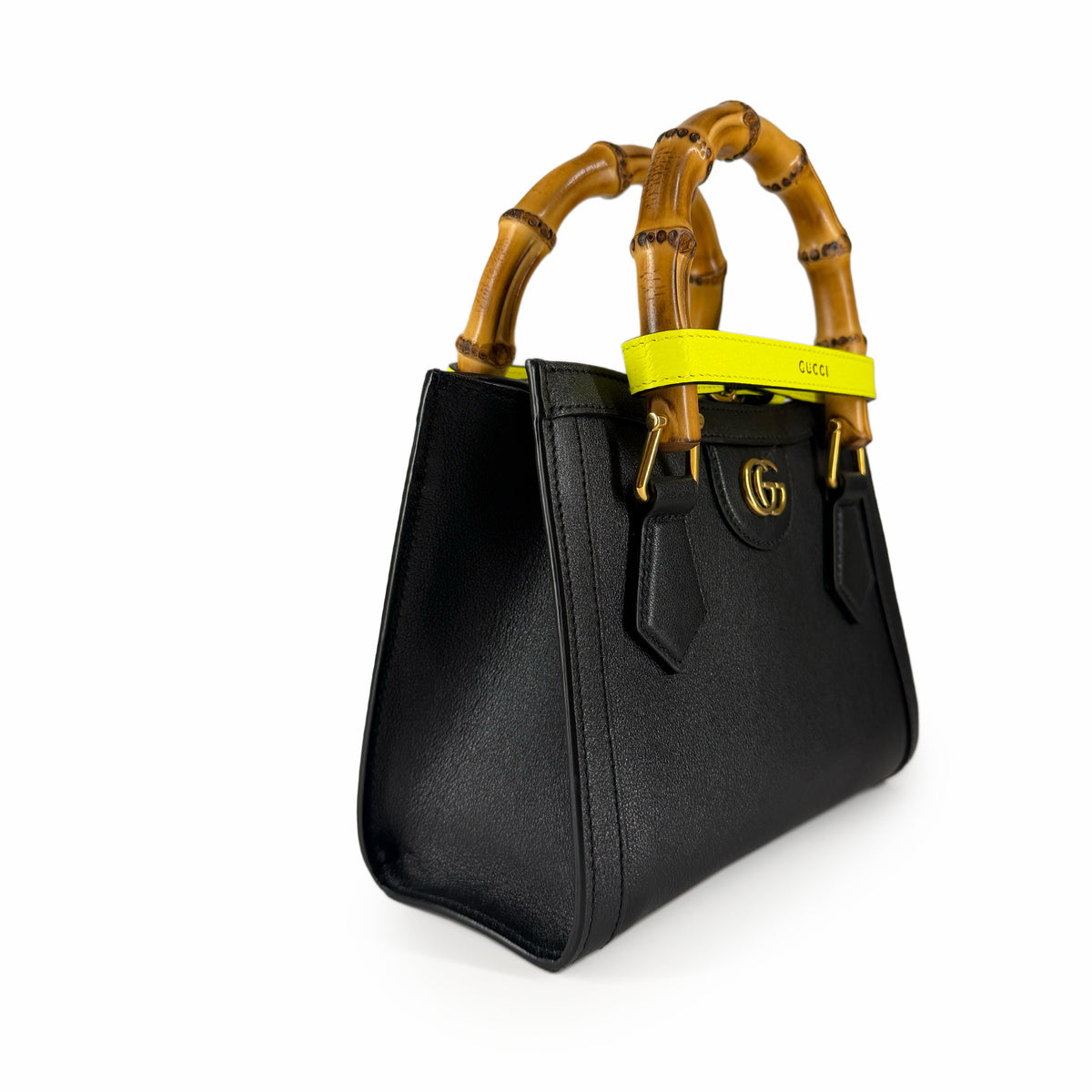 Black leather handbag with bamboo handles and yellow strap, curated Pre-loved Luxury by Myluxe in Helsinki.