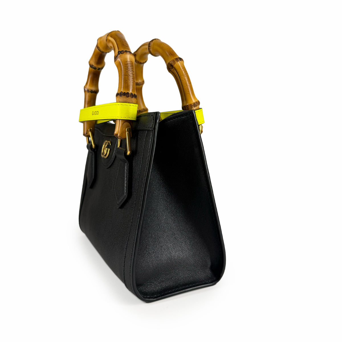 Black leather Gucci handbag with bamboo handles and yellow accents, curated Pre-loved Luxury by Myluxe in Helsinki.