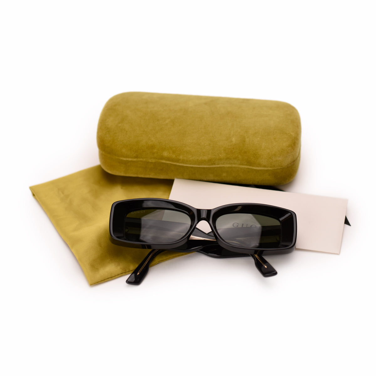 Black Gucci rectangular sunglasses with olive green velvet case and pouch. curated Pre-loved Luxury by Myluxe in Helsinki.