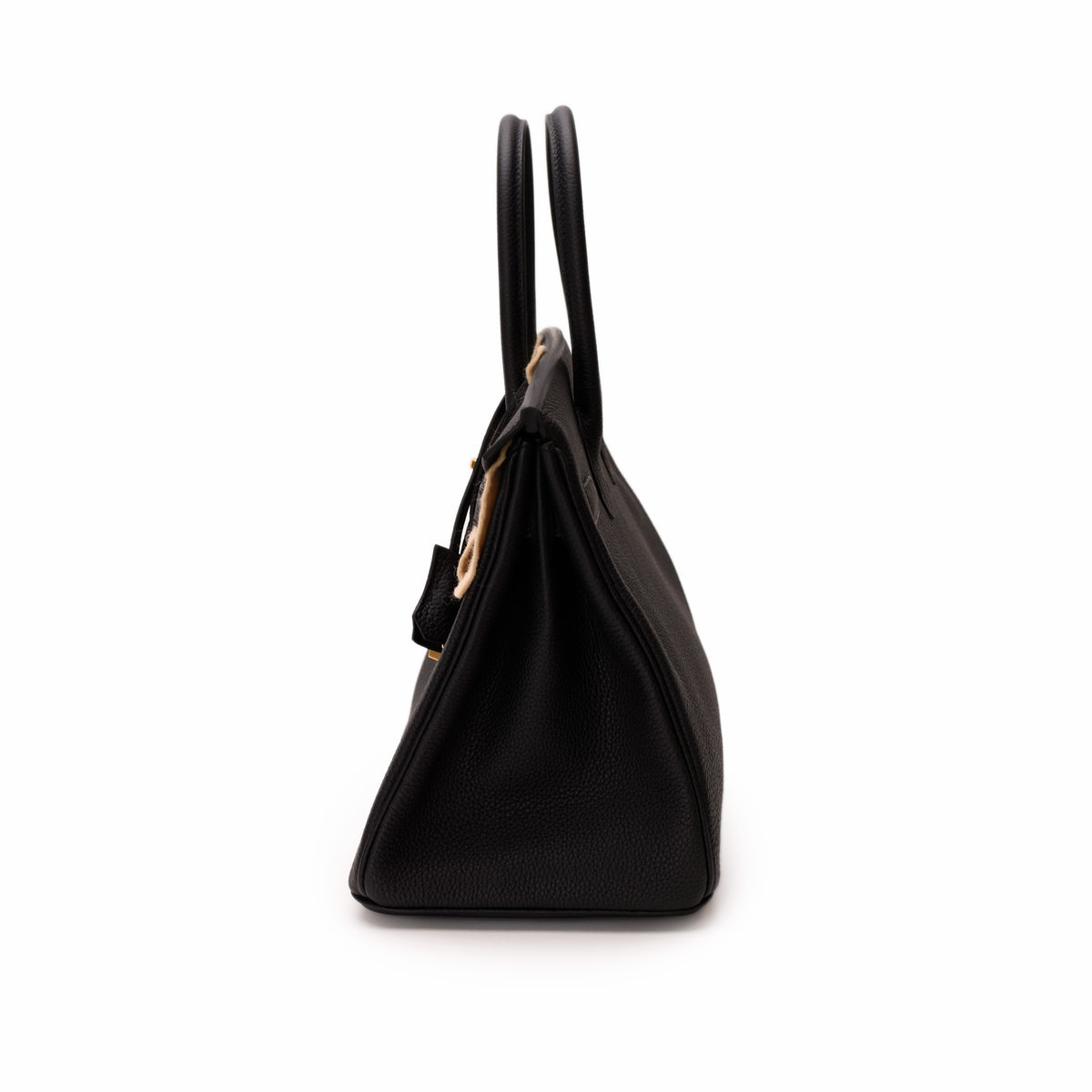 Side view of a black grained leather handbag with top handles, curated Pre-loved Luxury by Myluxe in Helsinki.