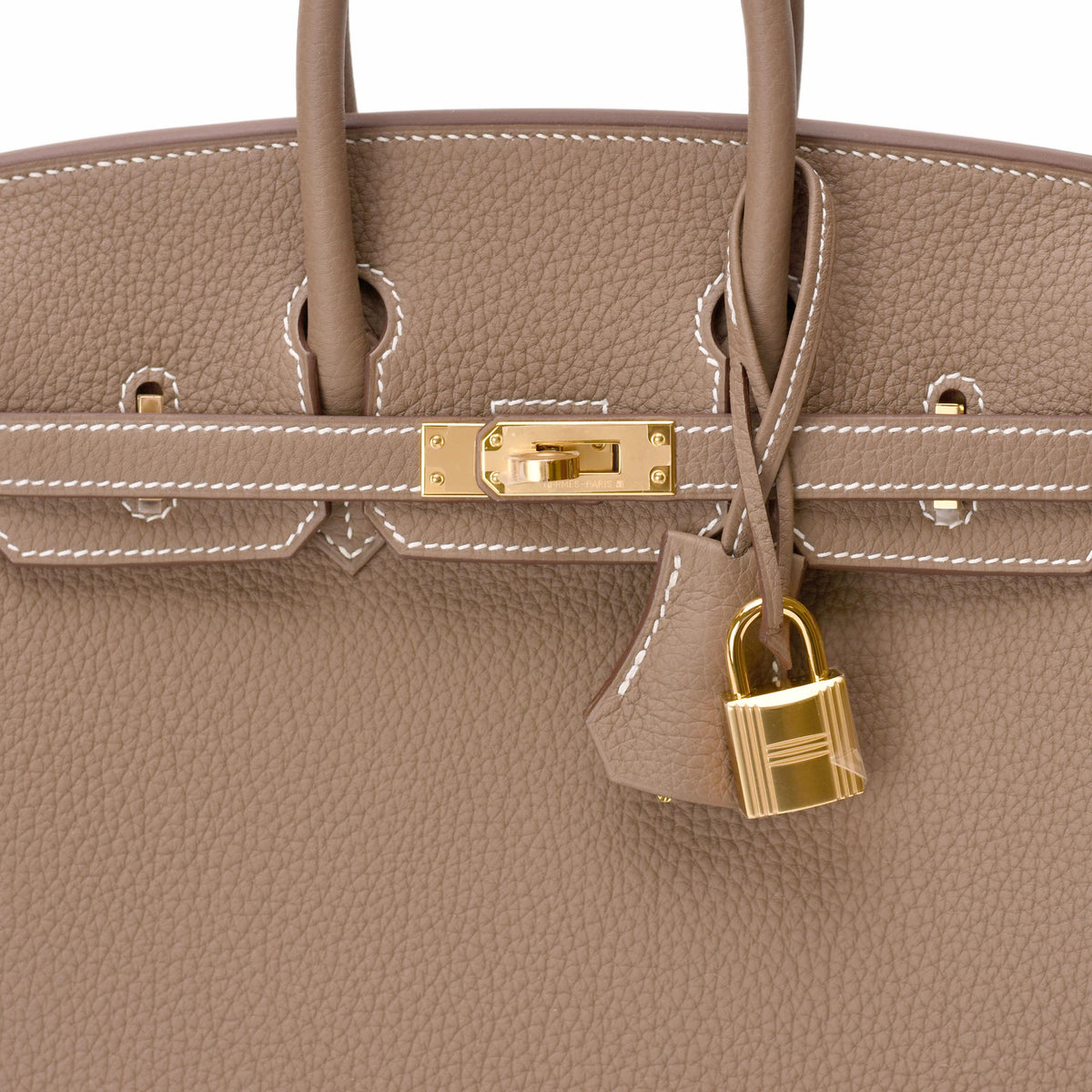 Hermès taupe leather handbag with gold-tone hardware and padlock. curated Pre-loved Luxury by Myluxe in Helsinki.