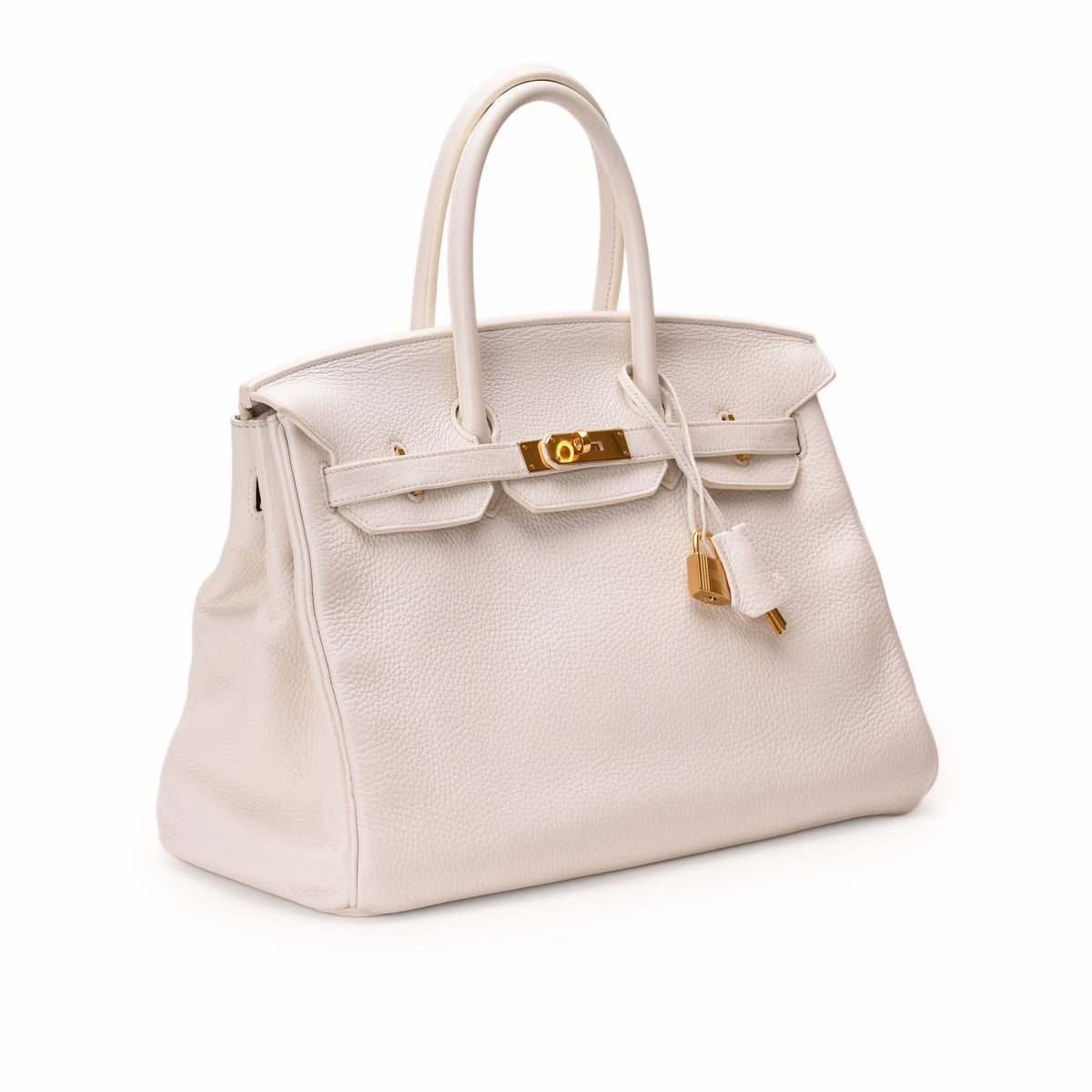 Hermès Birkin handbag in white grained leather with gold-tone hardware. curated Pre-loved Luxury by Myluxe in Helsinki.