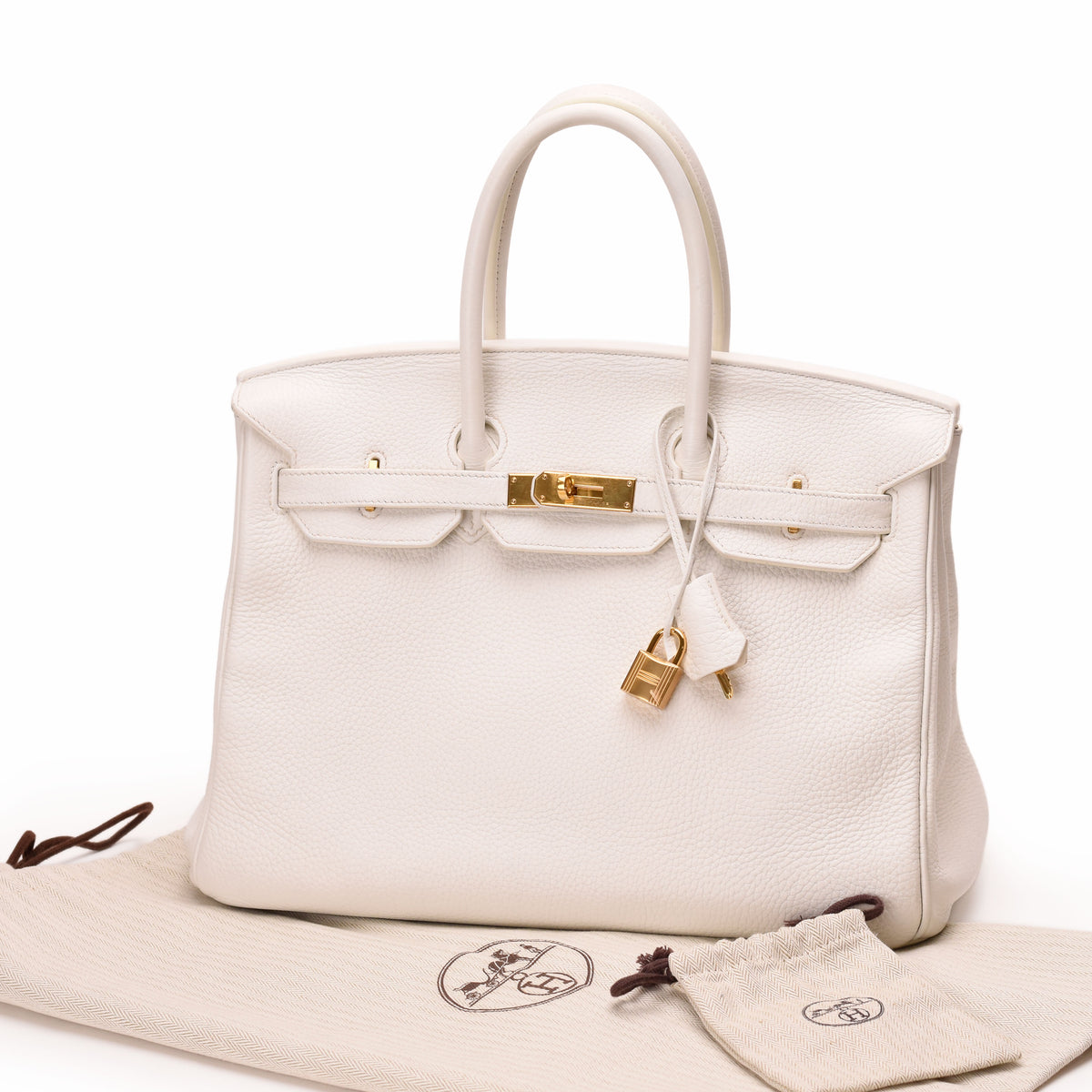 White Hermès Togo leather Birkin handbag with gold-tone hardware. curated Pre-loved Luxury by Myluxe in Helsinki.
