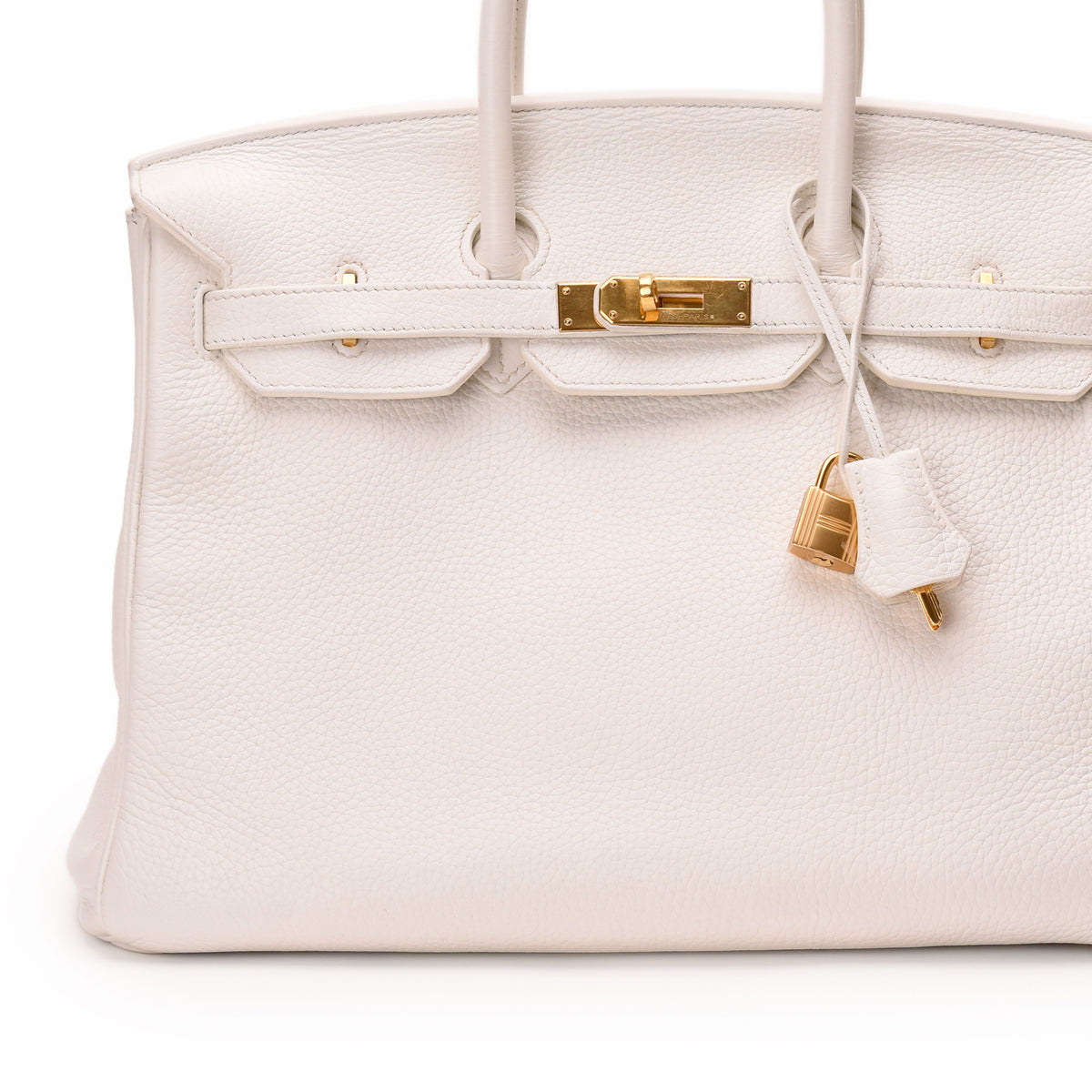 White leather Hermès Birkin handbag with gold-tone hardware and padlock. curated Pre-loved Luxury by Myluxe in Helsinki.