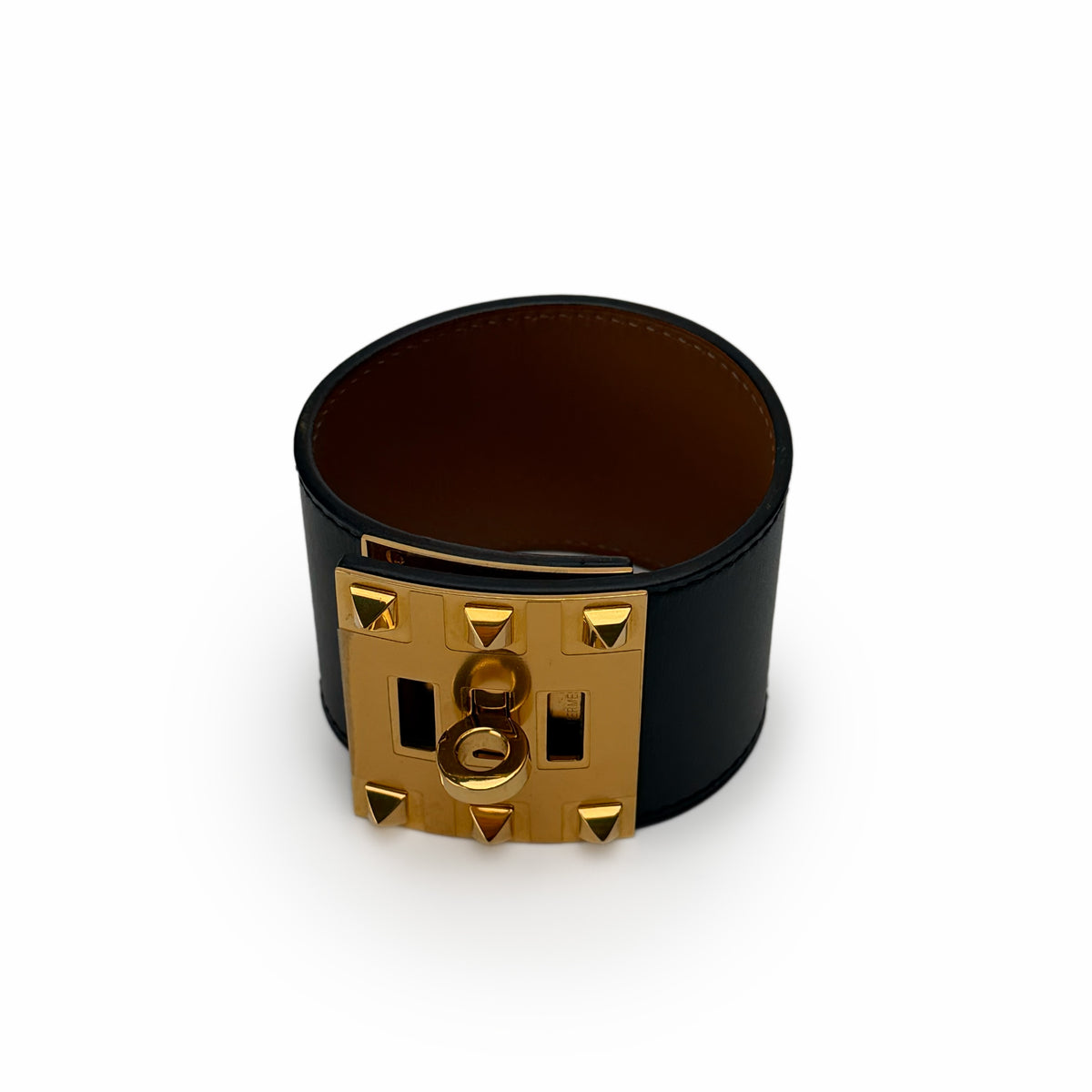 Black leather wide cuff bracelet with gold-tone pyramid stud hardware, curated Pre-loved Luxury by Myluxe in Helsinki.