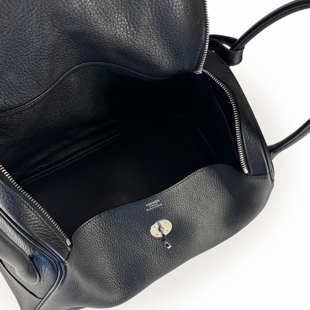 Interior view of a black pebbled leather luxury handbag with silver hardware, curated Pre-loved Luxury by Myluxe in Helsinki.