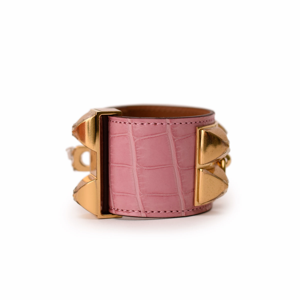 Pink crocodile-embossed leather cuff bracelet with gold-tone hardware. curated Pre-loved Luxury by Myluxe in Helsinki.