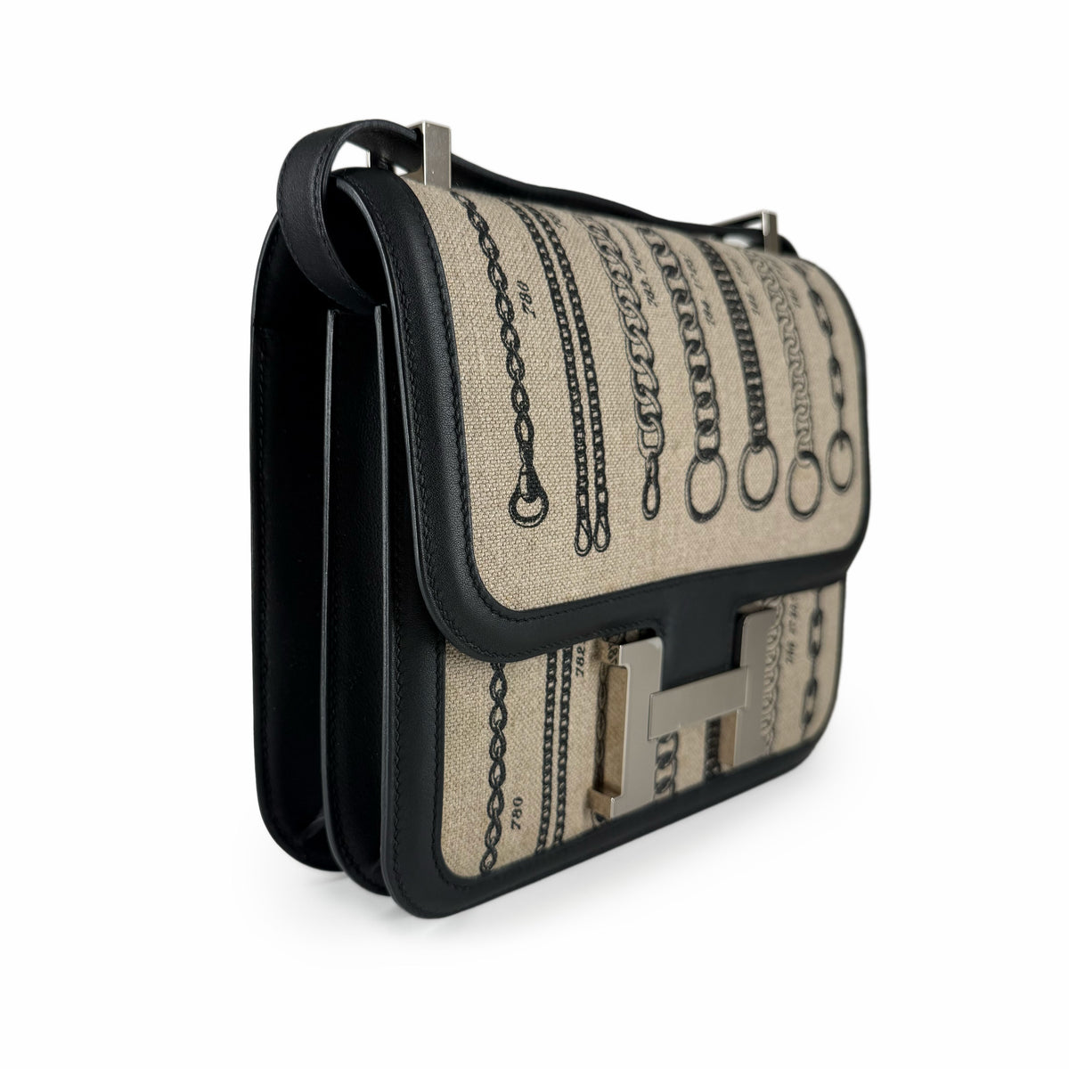 Beige canvas and black leather crossbody bag with chain print, curated Pre-loved Luxury by Myluxe in Helsinki.