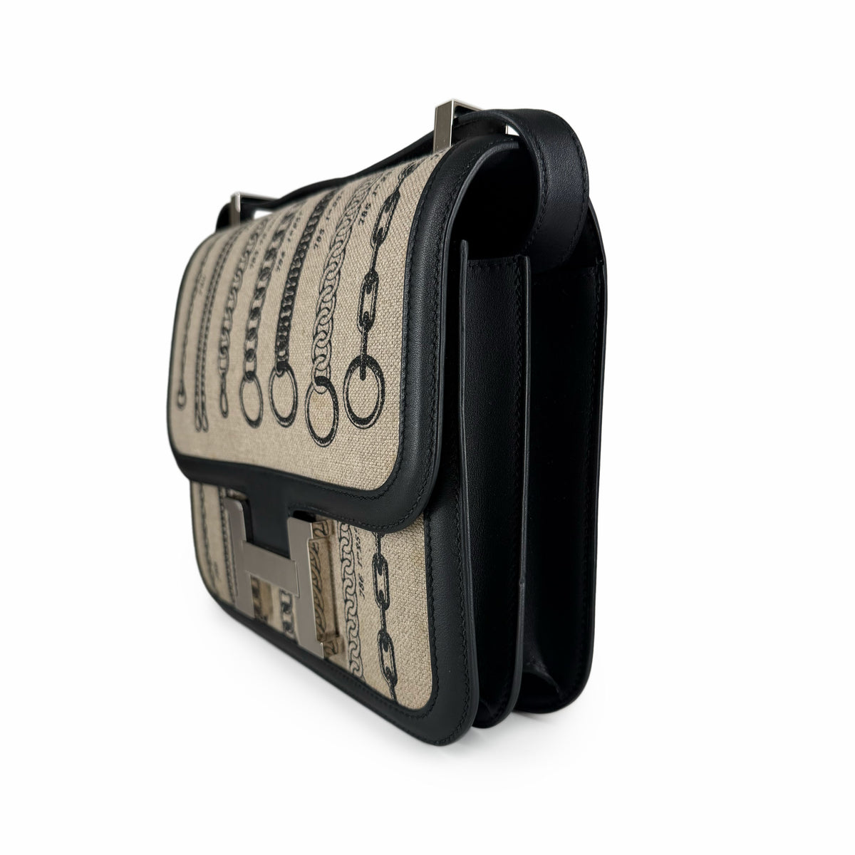 Beige canvas and black leather handbag with chain print and silver hardware, curated Pre-loved Luxury by Myluxe in Helsinki.