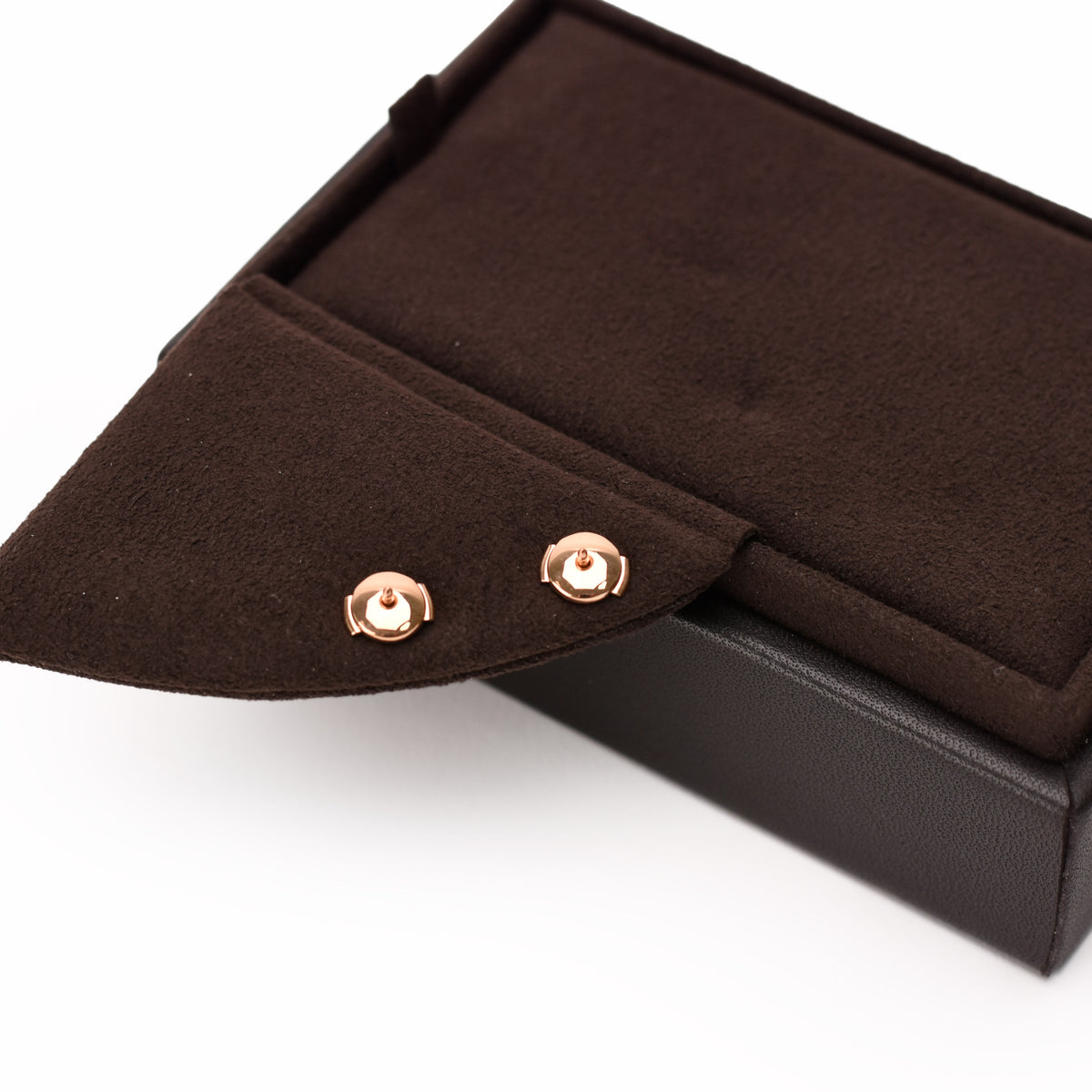 Rose gold stud earrings in a brown velvet jewelry box, curated Pre-loved Luxury by Myluxe in Helsinki.
