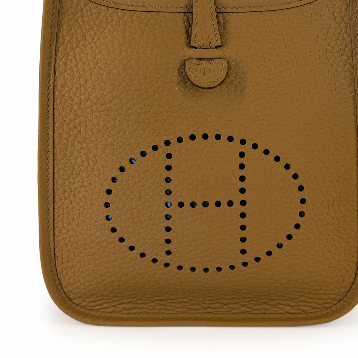 Tan pebbled leather handbag with perforated H logo detail, curated Pre-loved Luxury by Myluxe in Helsinki.