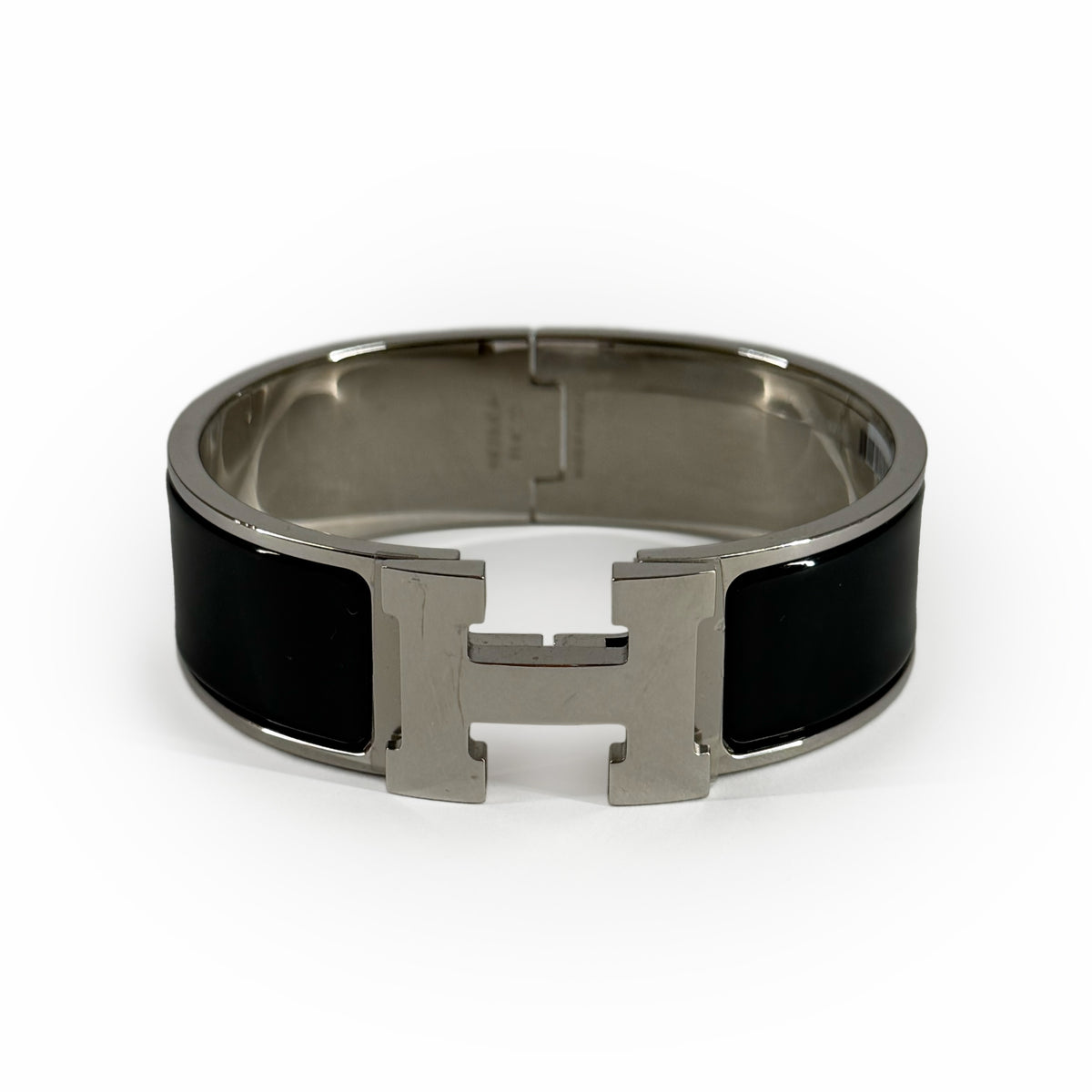 Silver-tone metal and black enamel H-motif bangle, curated Pre-loved Luxury by Myluxe in Helsinki.
