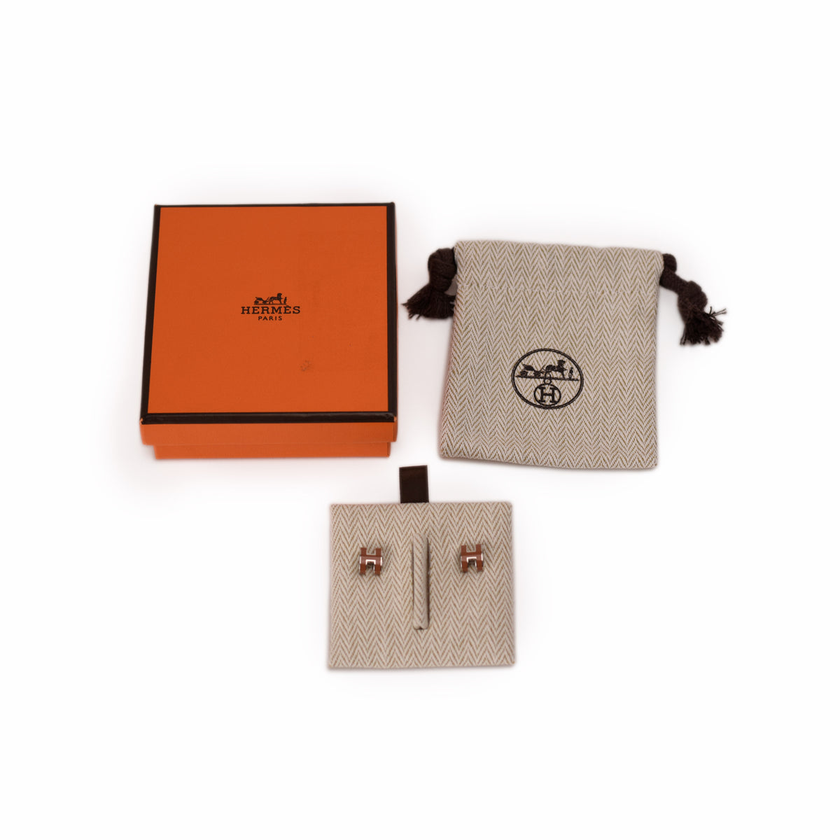 Hermès orange gift box, branded pouch, and earring card. curated Pre-loved Luxury by Myluxe in Helsinki.