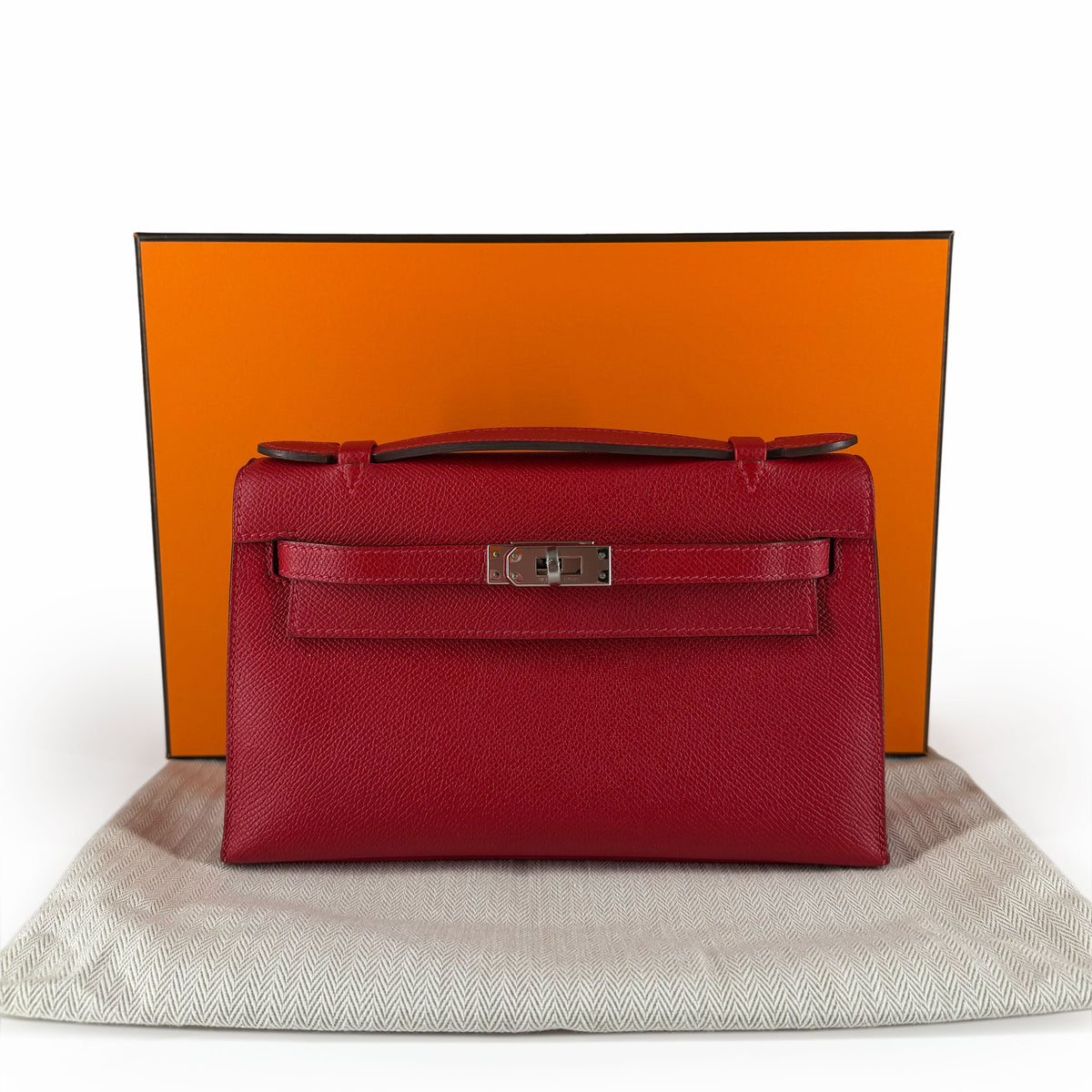 Red leather Hermès Kelly handbag with silver hardware, curated Pre-loved Luxury by Myluxe in Helsinki.